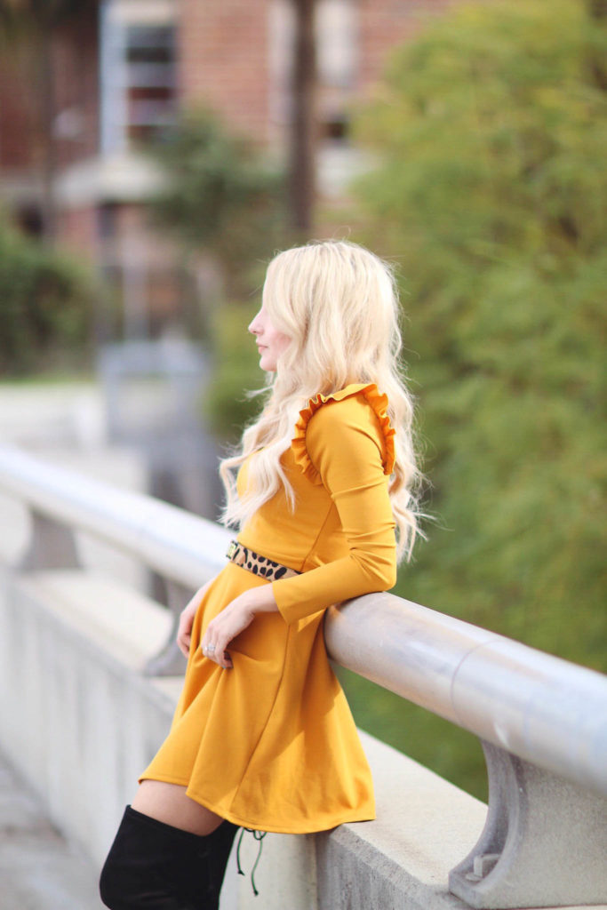 Alena Gidenko of modaprints.com styles a yellow ruffled dress with over the knee black boots