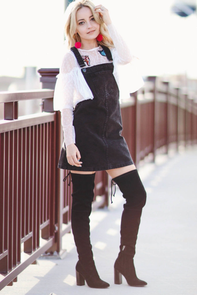 Alena Gidenko of modaprints.com styles a black overalls dress with over the knee boots