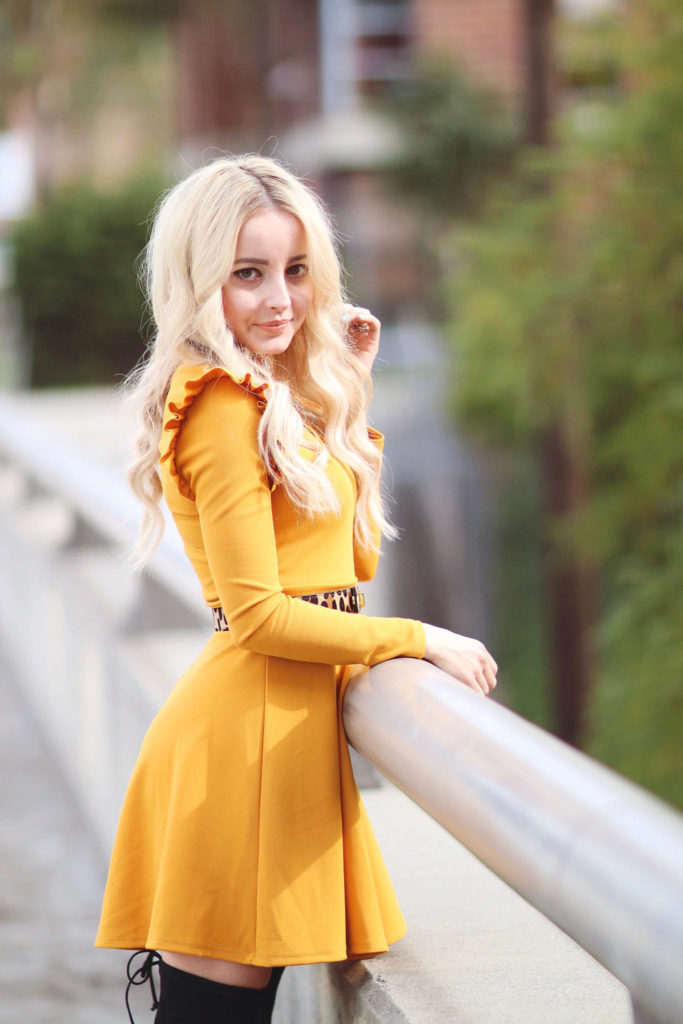 Alena Gidenko of modaprints.com styles a yellow ruffled dress with over the knee black boots