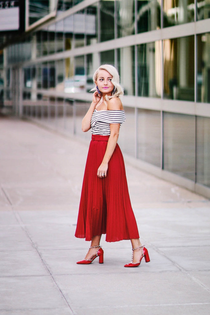 TAKING YOUR RED PLEATED SKIRT