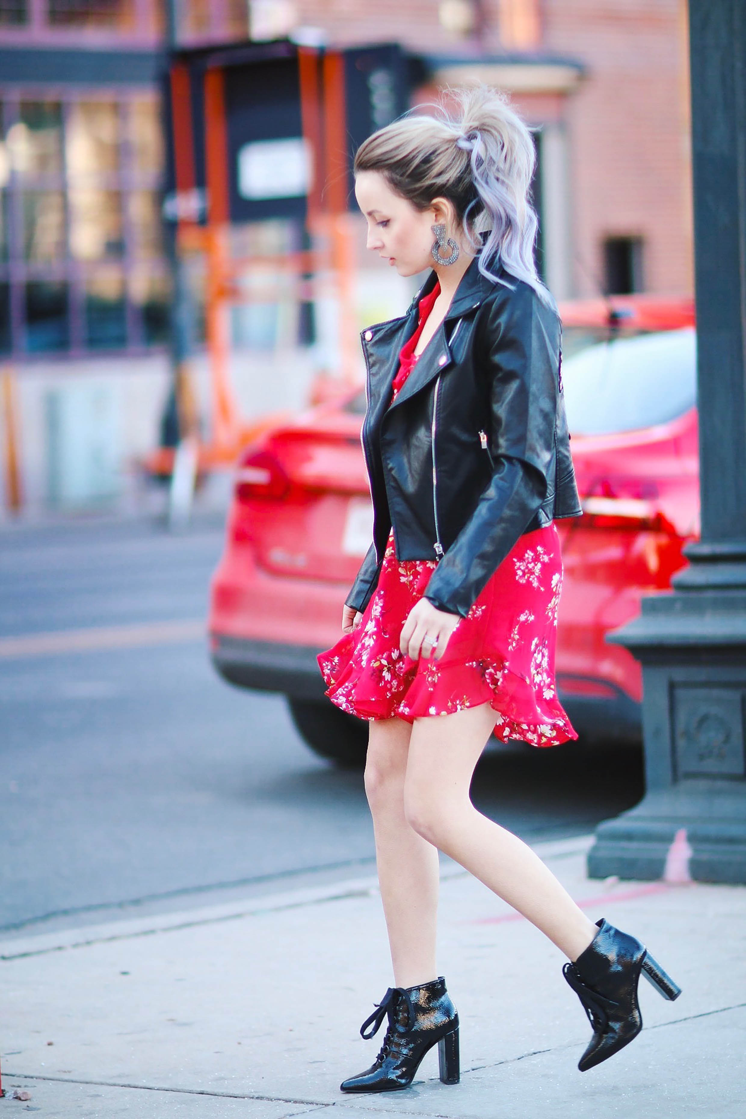 Alena Gidenko of modapcrits.com styles a red floral dress with a black faux leather floral jacket