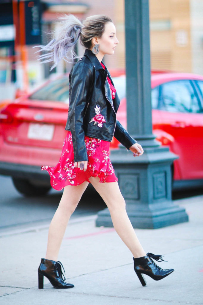 Alena Gidenko of modapcrits.com styles a red floral dress with a black faux leather floral jacket
