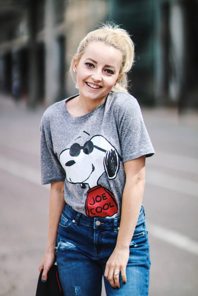 Alena Gidenko of modaprints.com styles a Snoopy tee shirt with boyfriend jeans and red studded heels