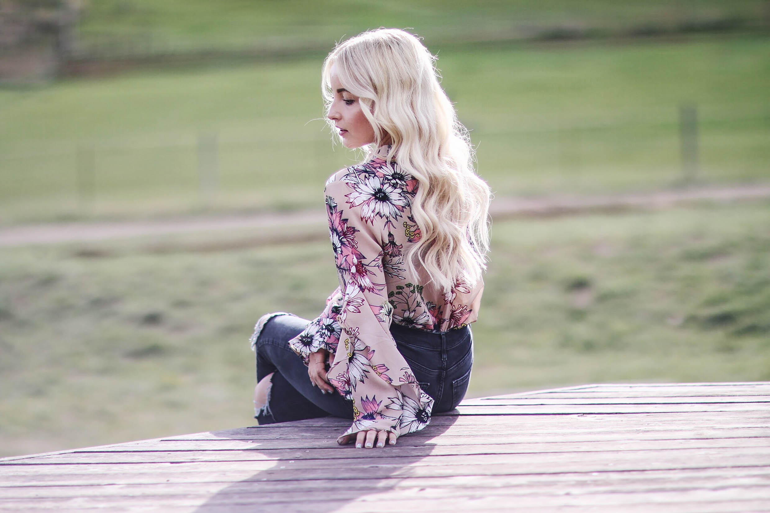 Alena Gidenko of modaprints.com styles a floral ruffled top with dark grey skinny jeans