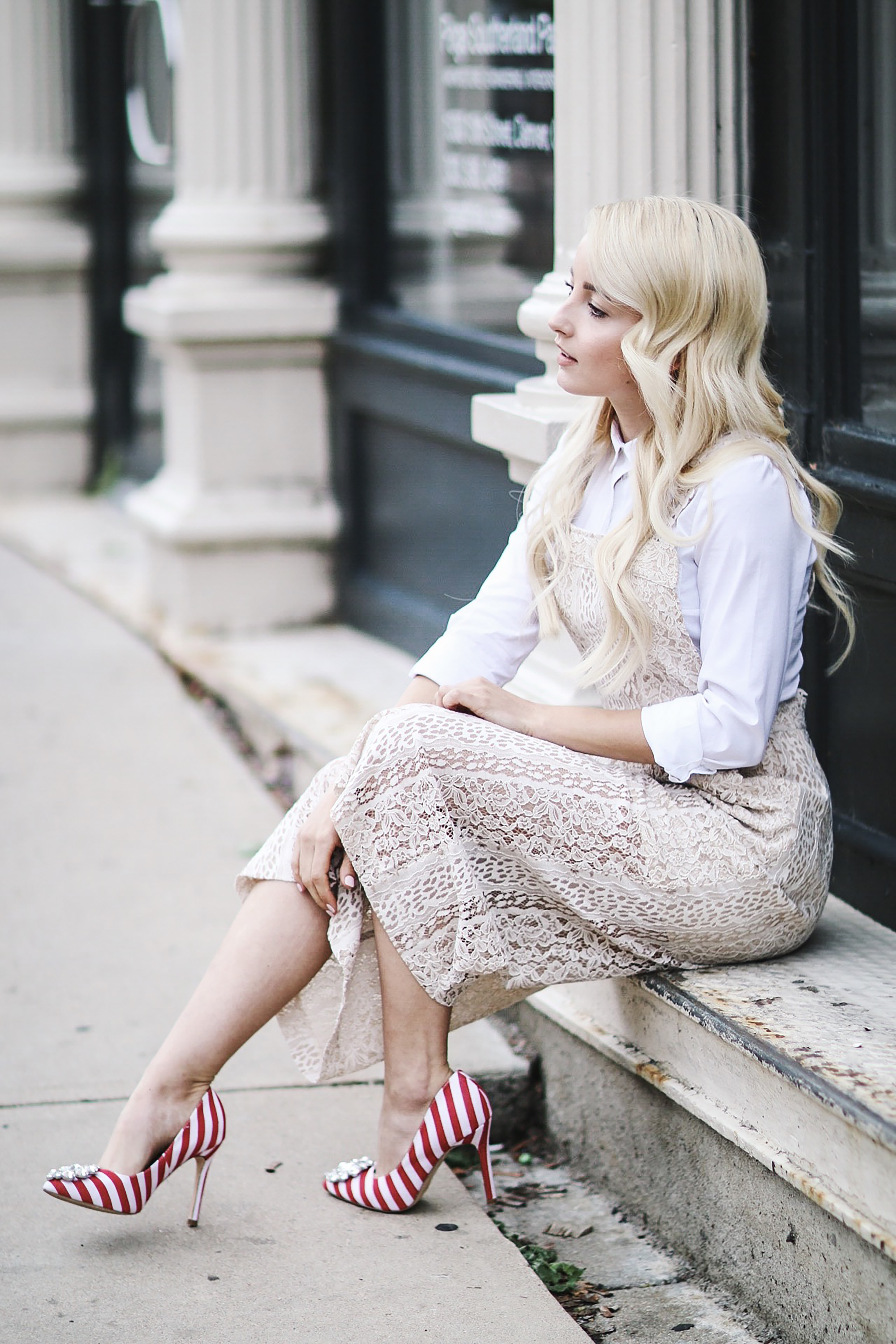 Alena Gidenko of modaprints.com styles a lace cream romper with a white button up and spices up the look with fun striped red heels