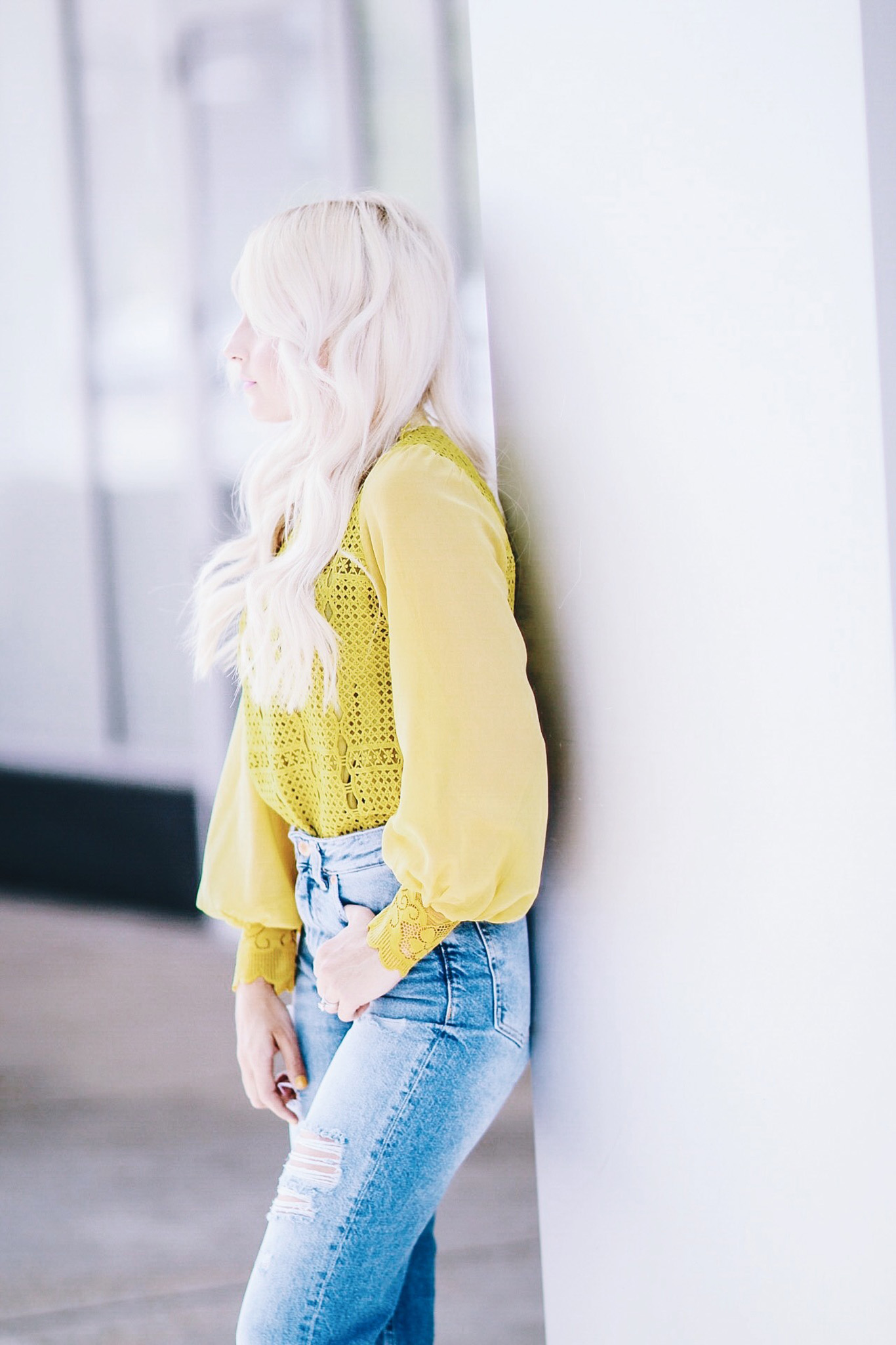 Alena Gidenko of modaprints.com styles a yellow lace top with high waisted mom jeans
