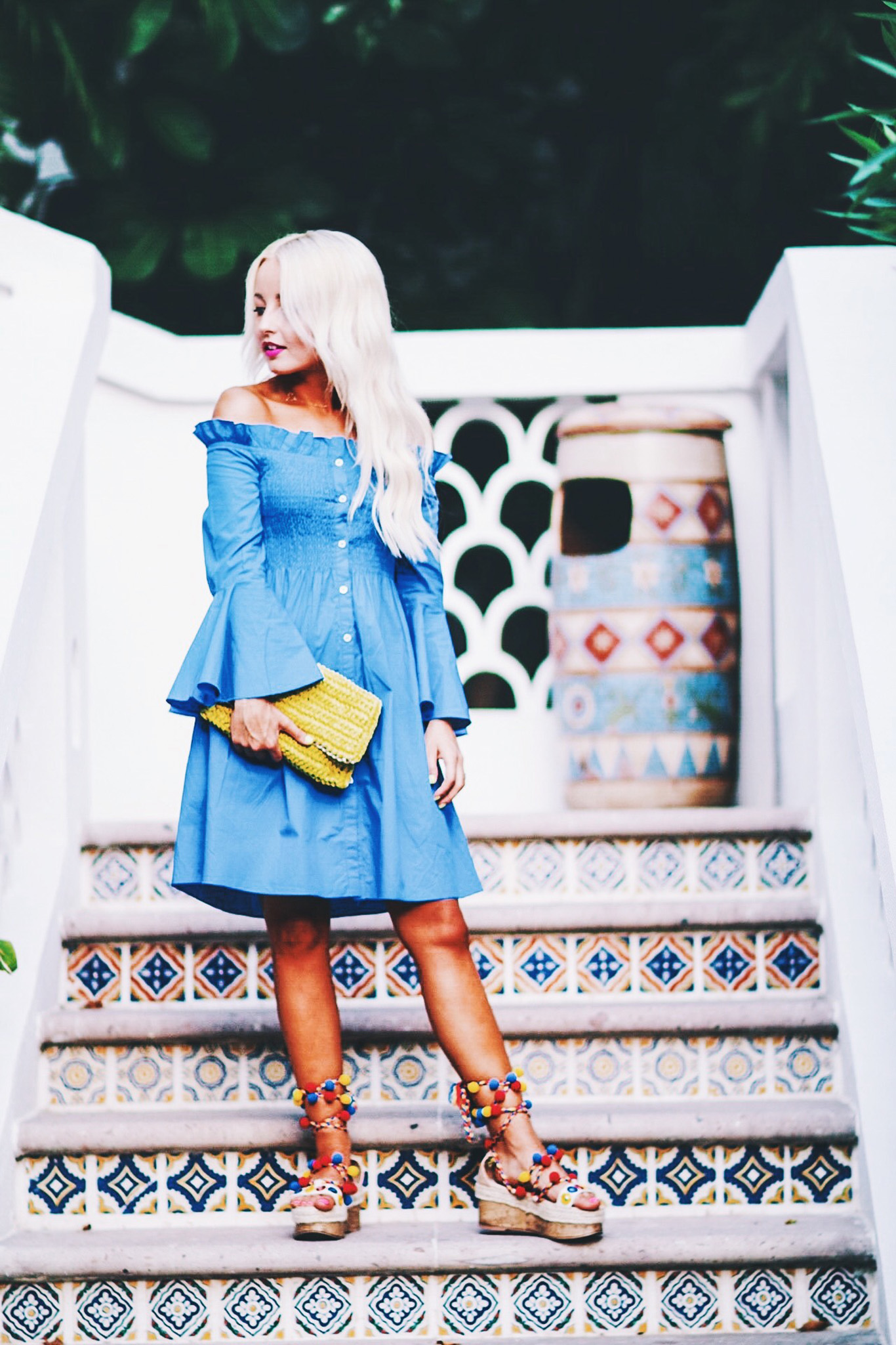 Alena Gidenko of modaprints.com styles a deep blue off the shoulder dress with pom pom sandals for Summer